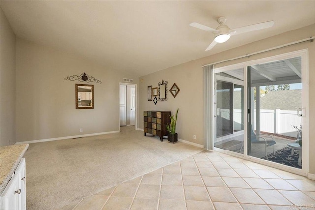 unfurnished room featuring light carpet, lofted ceiling, and ceiling fan