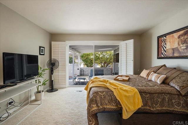 bedroom featuring light carpet and access to outside