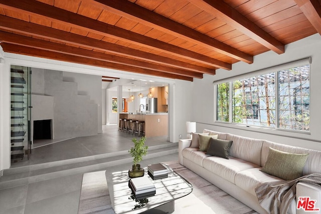 living room featuring beamed ceiling, sink, and wooden ceiling