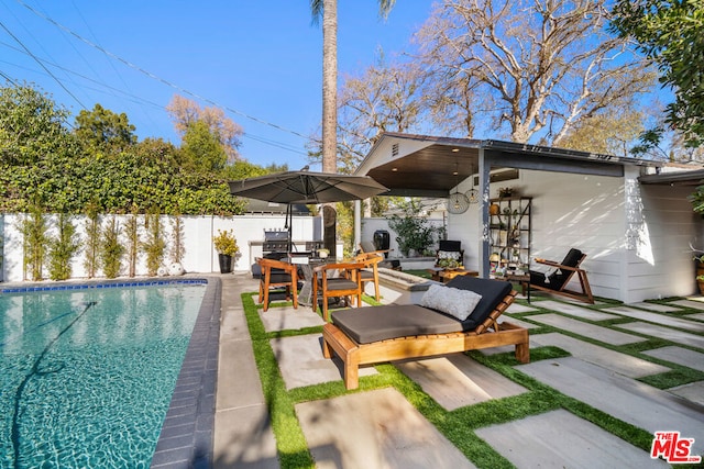 view of pool featuring a patio