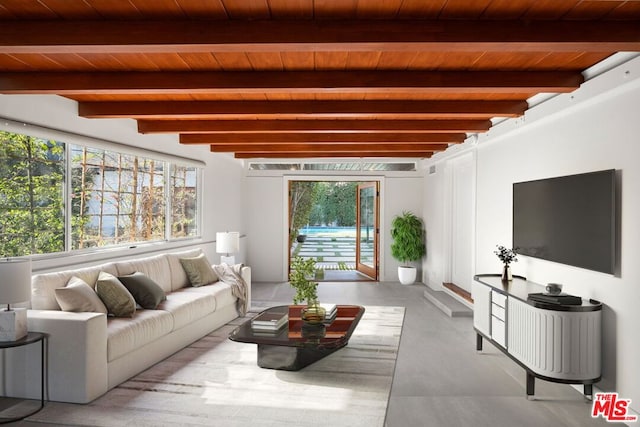 living room featuring a healthy amount of sunlight, wooden ceiling, and beam ceiling