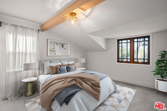 bedroom featuring lofted ceiling with beams