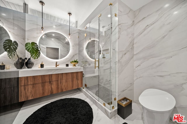 bathroom with vanity, an enclosed shower, and tile walls