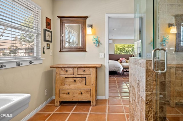 bathroom with tile patterned flooring and a shower with shower door