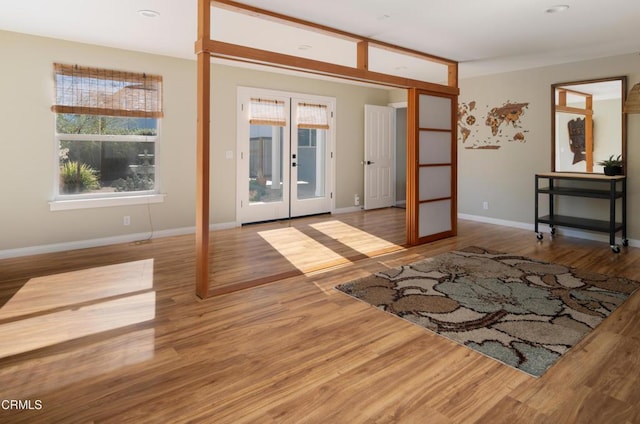 unfurnished room with french doors and wood-type flooring