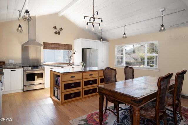 dining space featuring light hardwood / wood-style flooring and lofted ceiling with beams