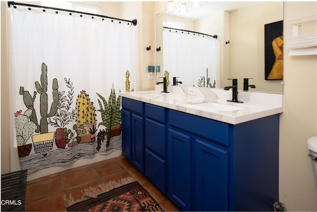 bathroom with tile patterned flooring, vanity, and shower / bath combo