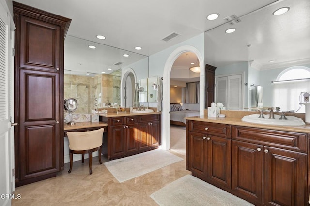 bathroom with ornamental molding, vanity, and a shower with shower door