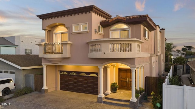 mediterranean / spanish house with a garage and a balcony