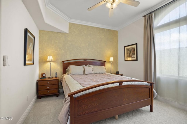 carpeted bedroom featuring crown molding and ceiling fan