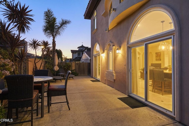 view of patio terrace at dusk