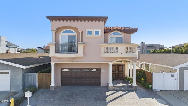 view of front facade with a garage and a balcony