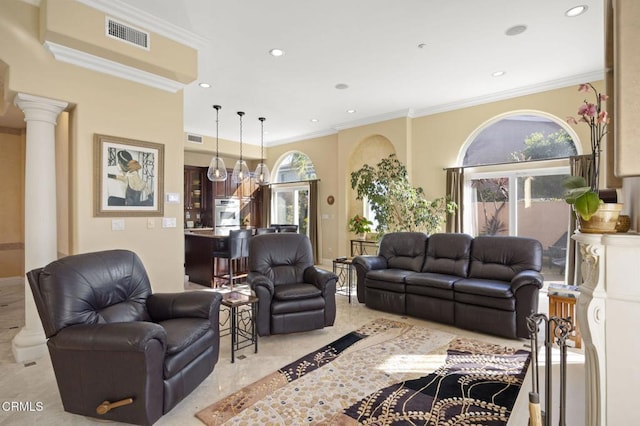 living room featuring decorative columns and ornamental molding