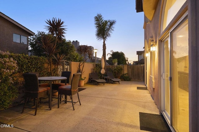 view of patio terrace at dusk