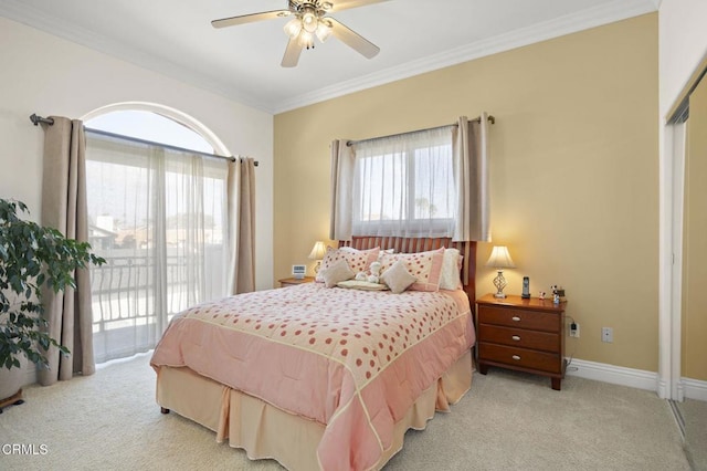 carpeted bedroom featuring multiple windows, crown molding, access to exterior, and ceiling fan