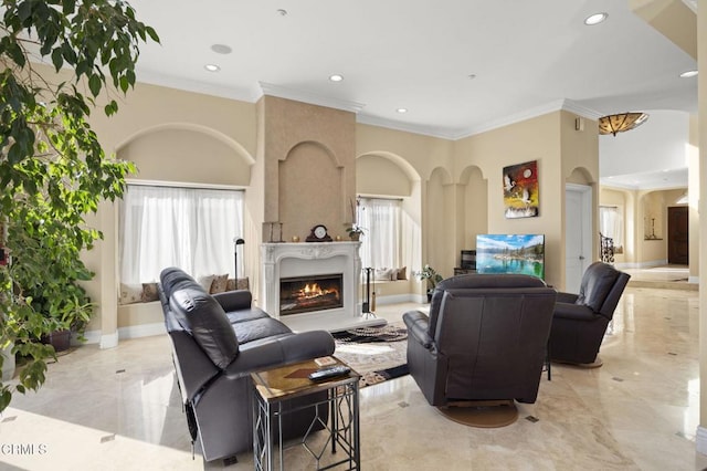 living room featuring ornamental molding and a large fireplace