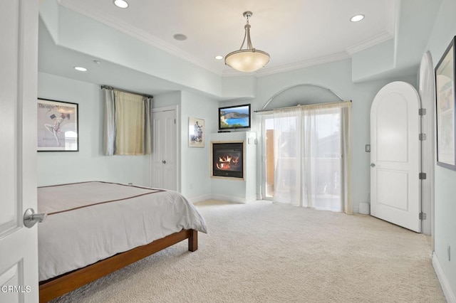 bedroom with ornamental molding, light carpet, and a closet