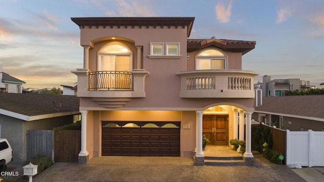 view of front of house featuring a balcony and a garage