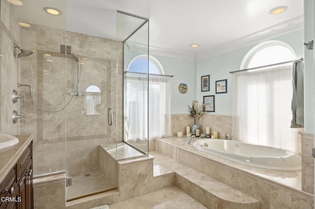 bathroom featuring vanity, crown molding, and separate shower and tub