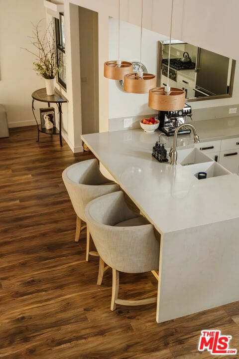 kitchen with sink, dark wood-type flooring, and white cabinets