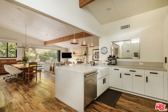 kitchen with pendant lighting, lofted ceiling with beams, white cabinets, stainless steel dishwasher, and kitchen peninsula