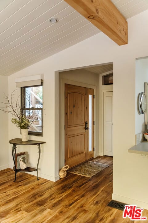 foyer entrance featuring vaulted ceiling with beams, wood-type flooring, and wooden ceiling