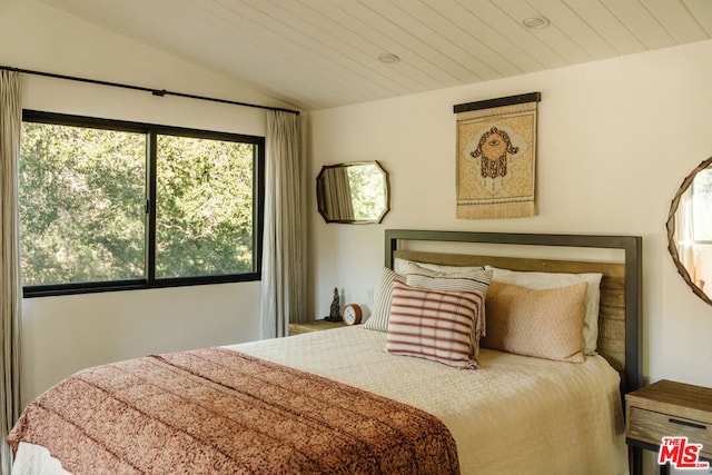 bedroom with lofted ceiling and wood ceiling