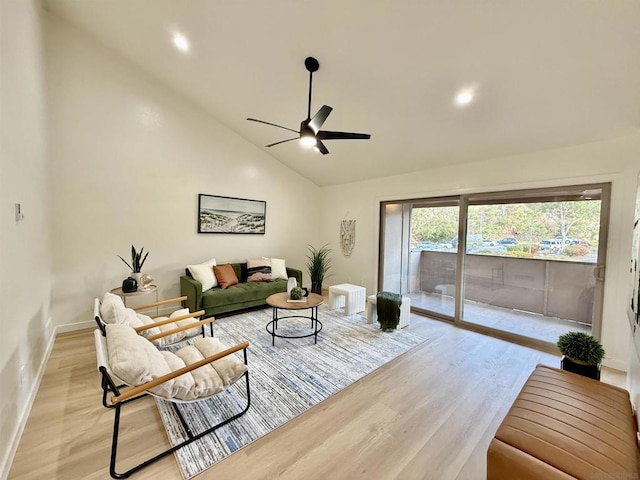 living room with ceiling fan, high vaulted ceiling, and light wood-type flooring