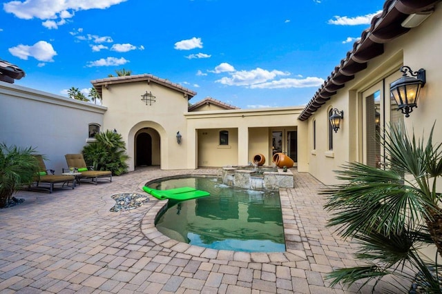 view of pool featuring a hot tub and a patio