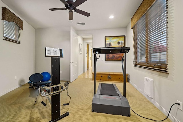 workout area with light colored carpet and ceiling fan