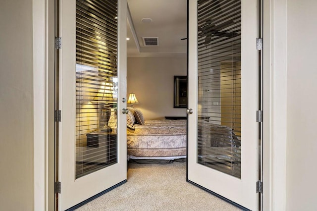 carpeted bedroom with french doors