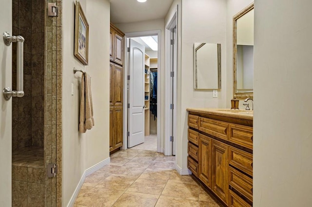 bathroom featuring vanity and a shower with door