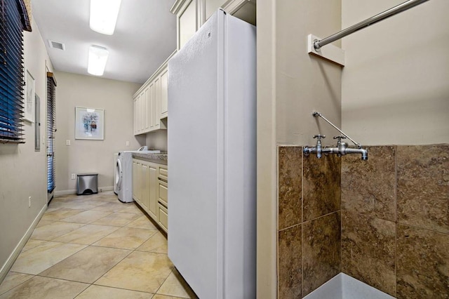 interior space with tile patterned flooring, a shower, and washer / dryer