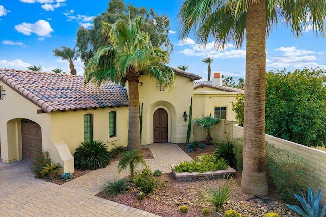 mediterranean / spanish house with a garage