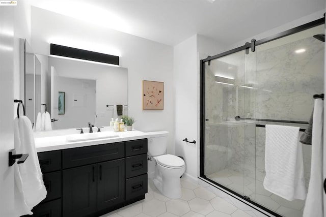 bathroom featuring vanity, an enclosed shower, and toilet