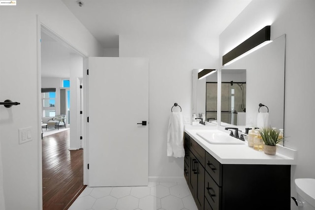 bathroom featuring vanity, a shower, and toilet