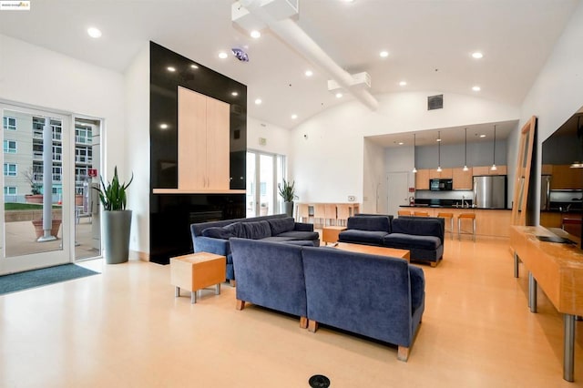 living room with high vaulted ceiling