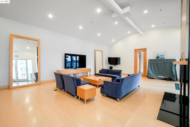 living room with light hardwood / wood-style floors and lofted ceiling with beams