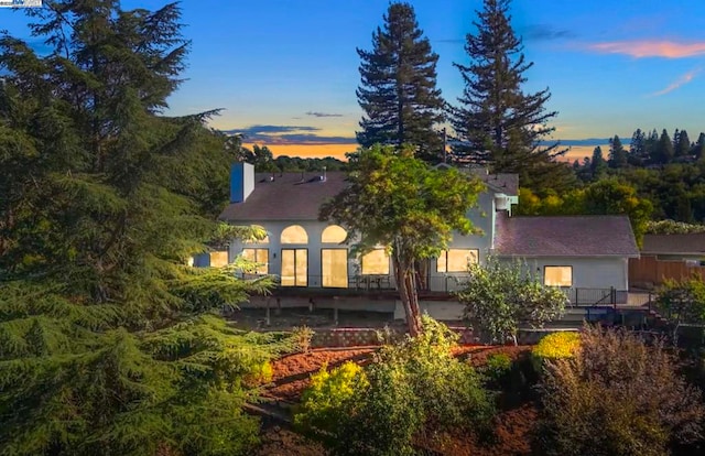 view of back house at dusk