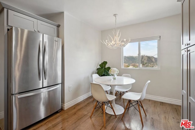 dining space featuring a chandelier and light wood-type flooring