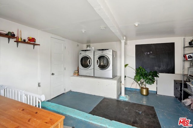 clothes washing area with washing machine and clothes dryer