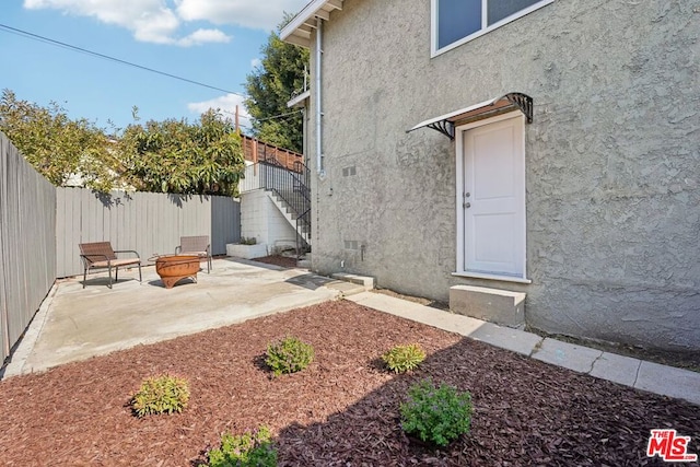 view of exterior entry with a patio area