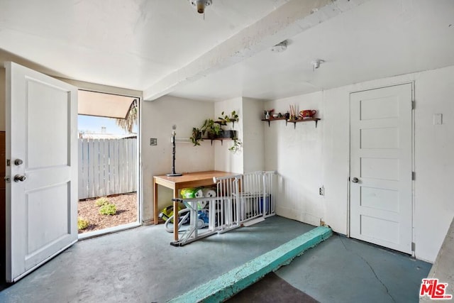 interior space with concrete floors and beamed ceiling