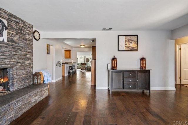 interior space featuring a fireplace and dark wood-type flooring