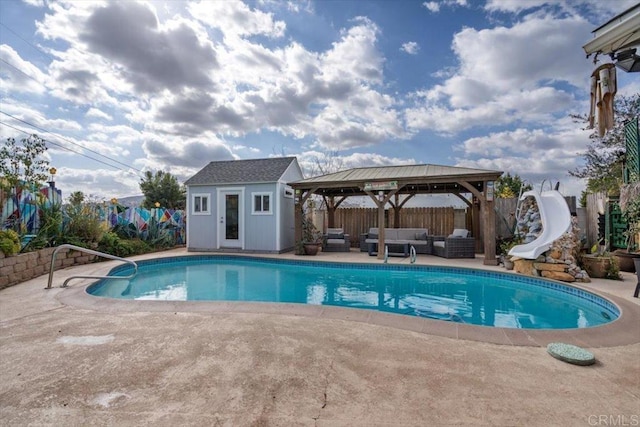 view of pool featuring a water slide, a gazebo, an outdoor living space, a patio area, and an outdoor structure