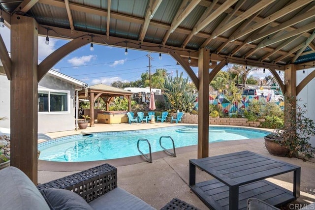 view of pool with a gazebo, a patio area, and a hot tub