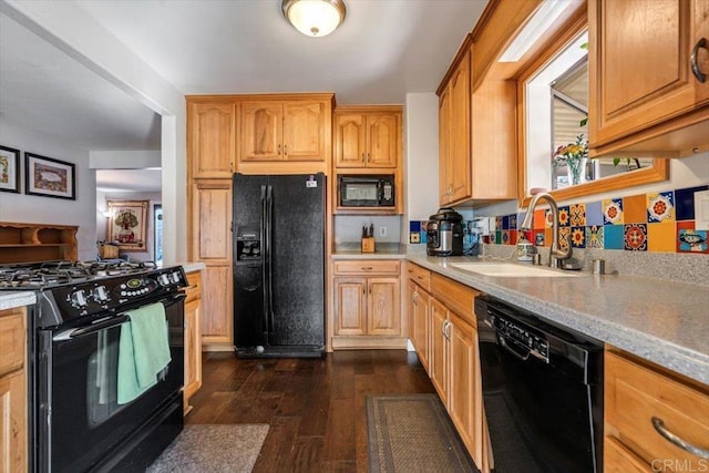 kitchen featuring sink, dark wood-type flooring, and black appliances