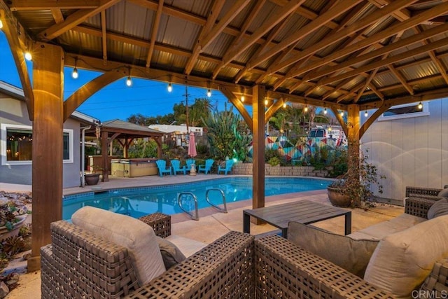 view of swimming pool featuring a gazebo and a patio area