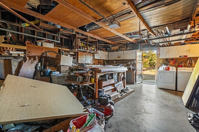 miscellaneous room featuring washing machine and dryer and a workshop area