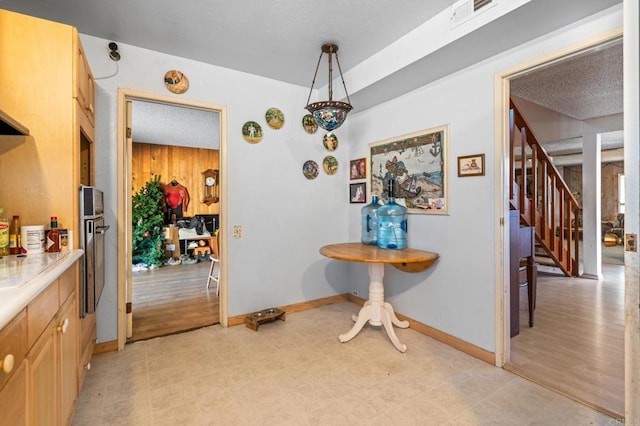 dining room with wood walls